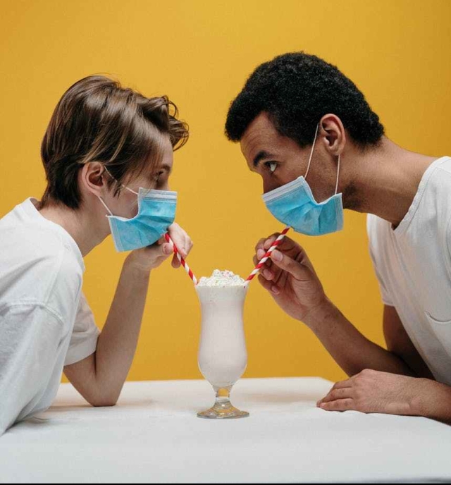 man and woman drinking milkshake